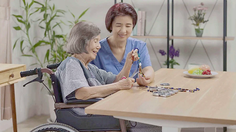 Older adult and caregiver enjoying conversation together