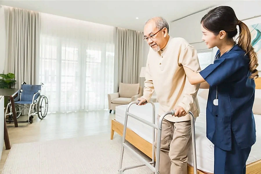 Caregiver gently supporting a senior at home